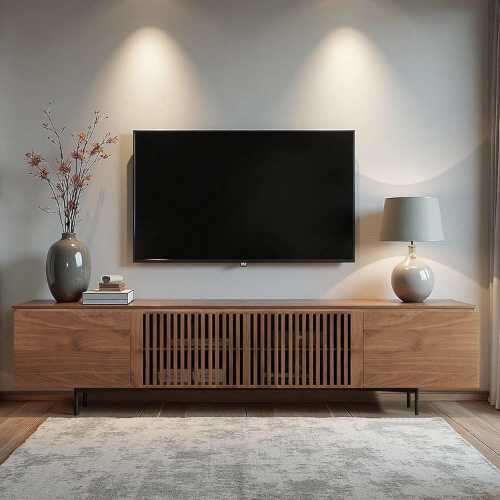 Modern living room with wooden TV stand, television, and decorative items.