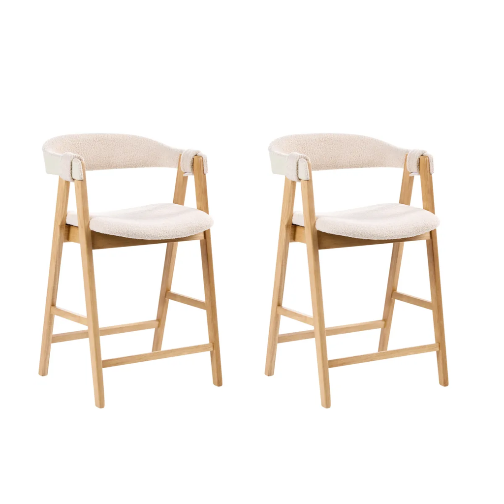 Two matching wooden bar stools with cream upholstered seats and curved backrests, shown side by side on a plain white background.