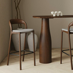 Wooden dining table with two Wooden Bar Stool with Grey Fabric Seat in a minimalistic setting.