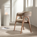 side view of the Beige Leather Dining Chair in a modern interior setting
