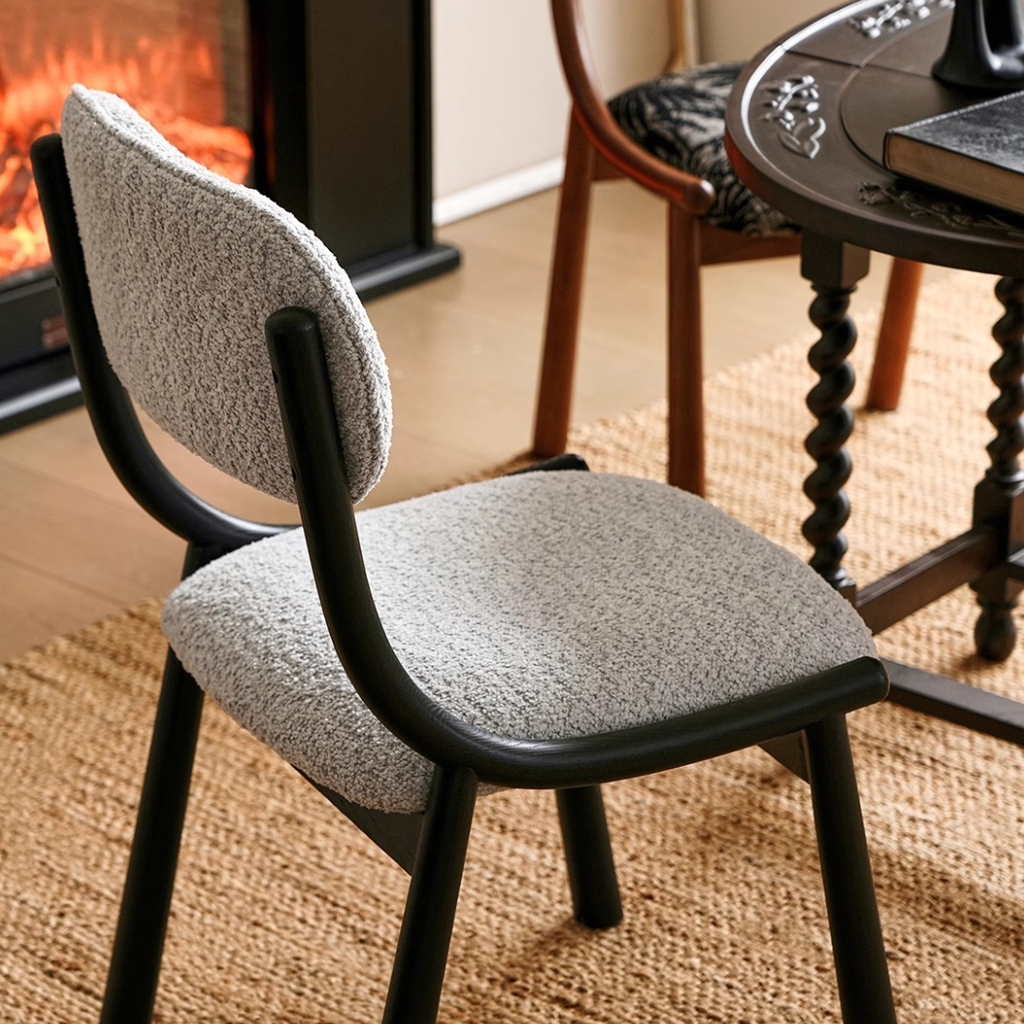 Black Metal And Boucle Fabric Dining Room Chair close up of the boucle fabric in a modern dining room