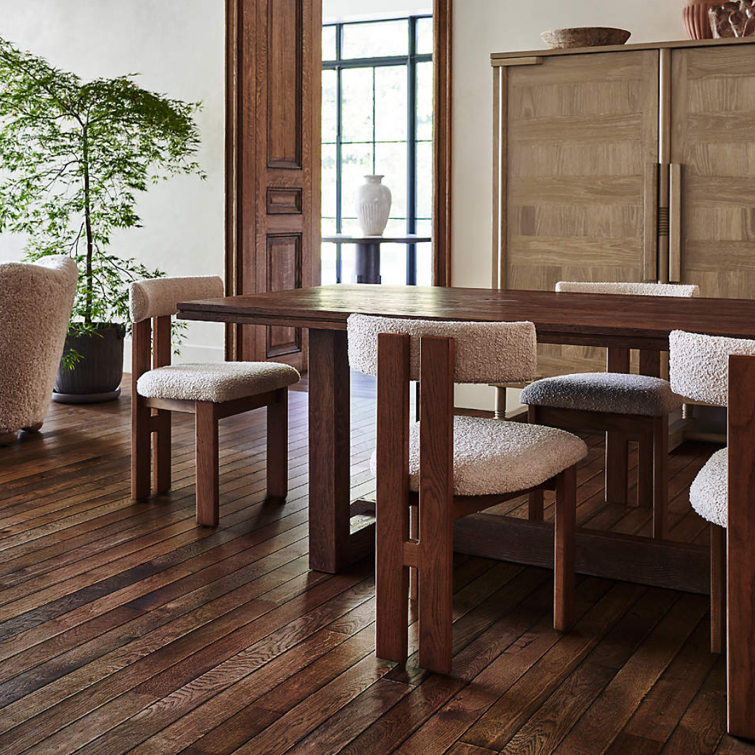 Dining room with wooden table and White Boucle Dining Chairs on a wooden floor.
