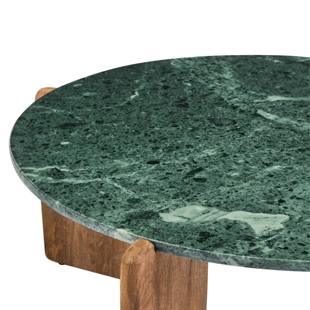 A close-up of a round green marble tabletop with natural veining and a wooden table base visible underneath, isolated on a white background.