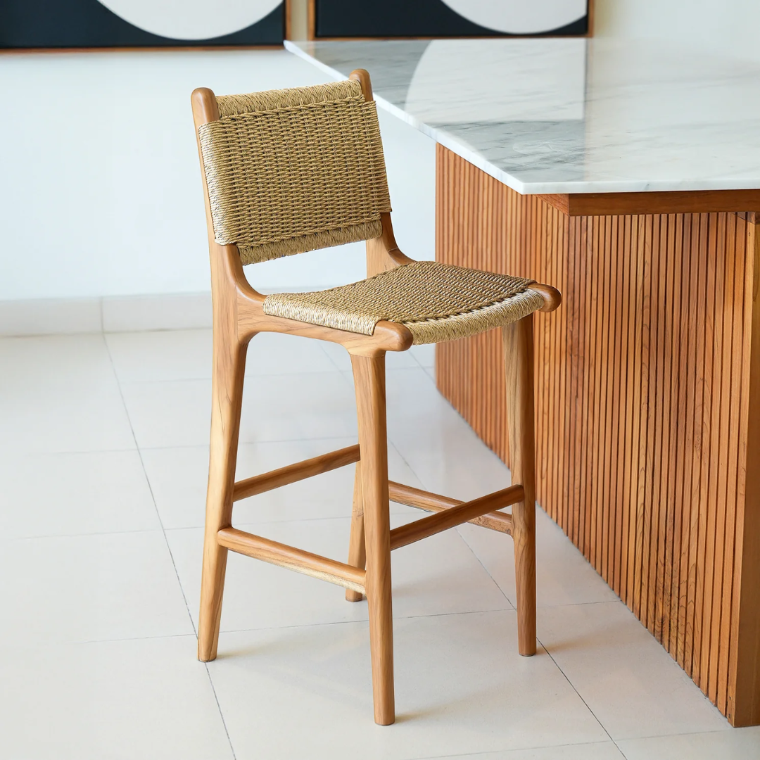 Wooden bar stool with rattan  seat and backrest in a modern kitchen setting.