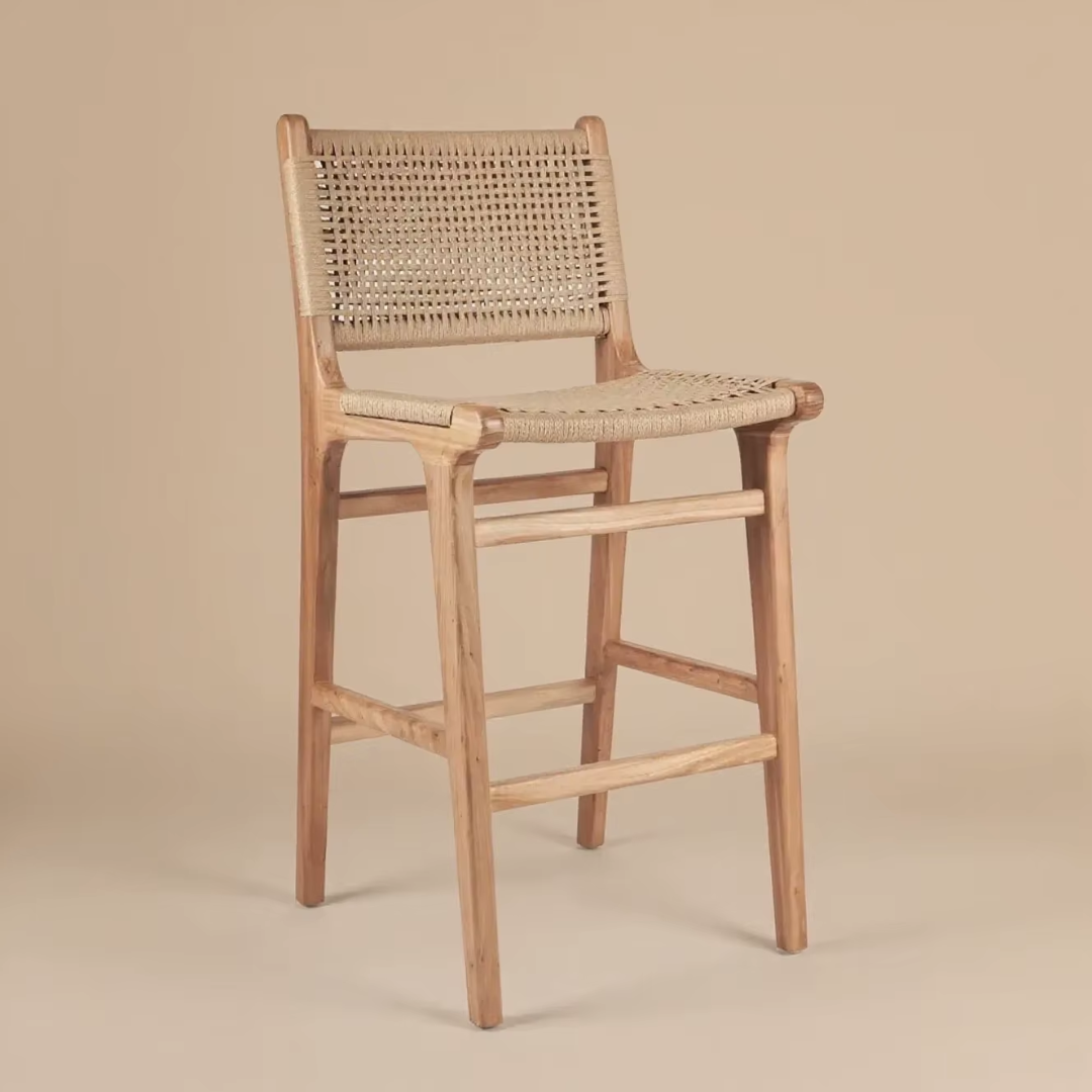 Wooden bar stool with rattan  backrest and seat on a beige background
