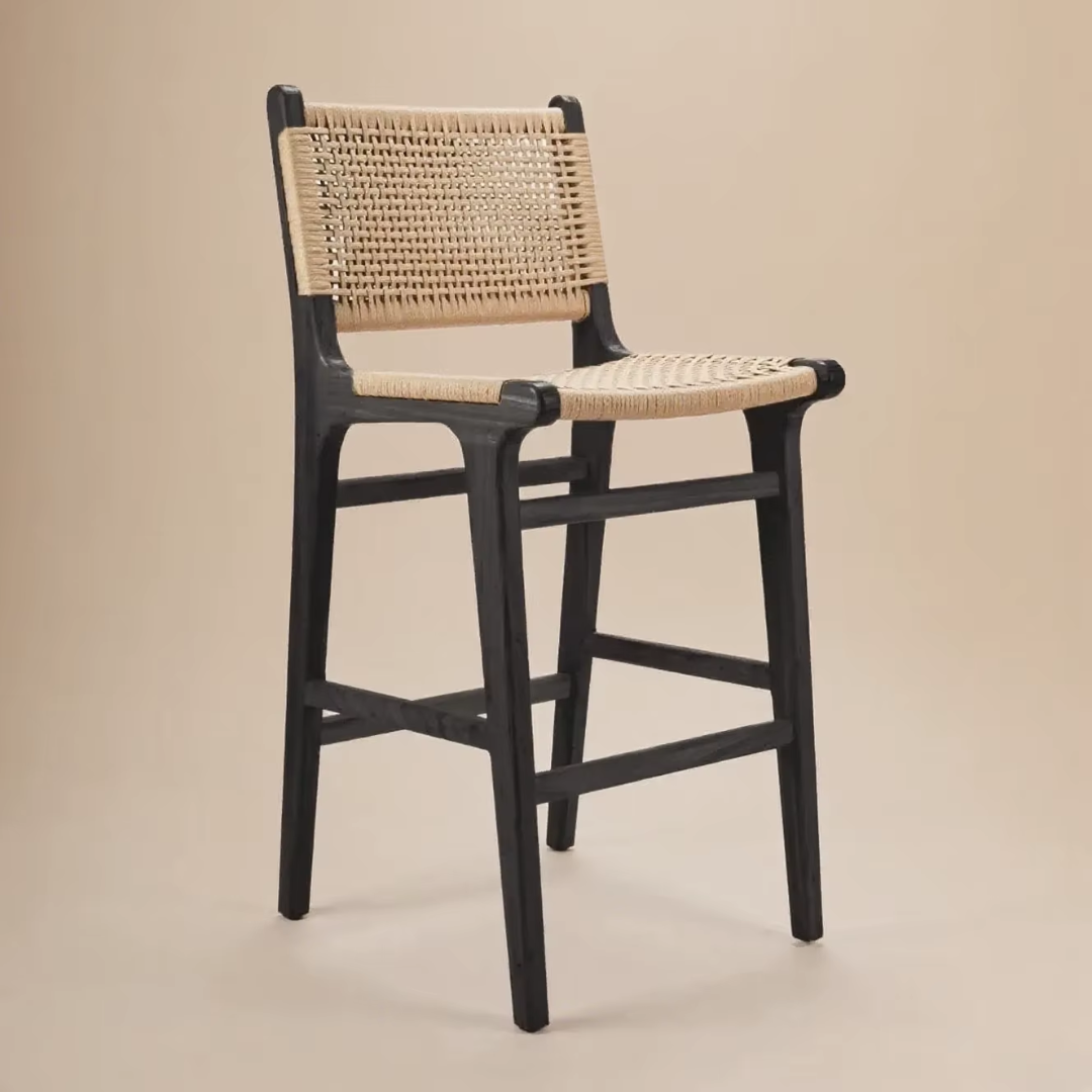 Bar stool with rattan  seat and backrest on a beige background