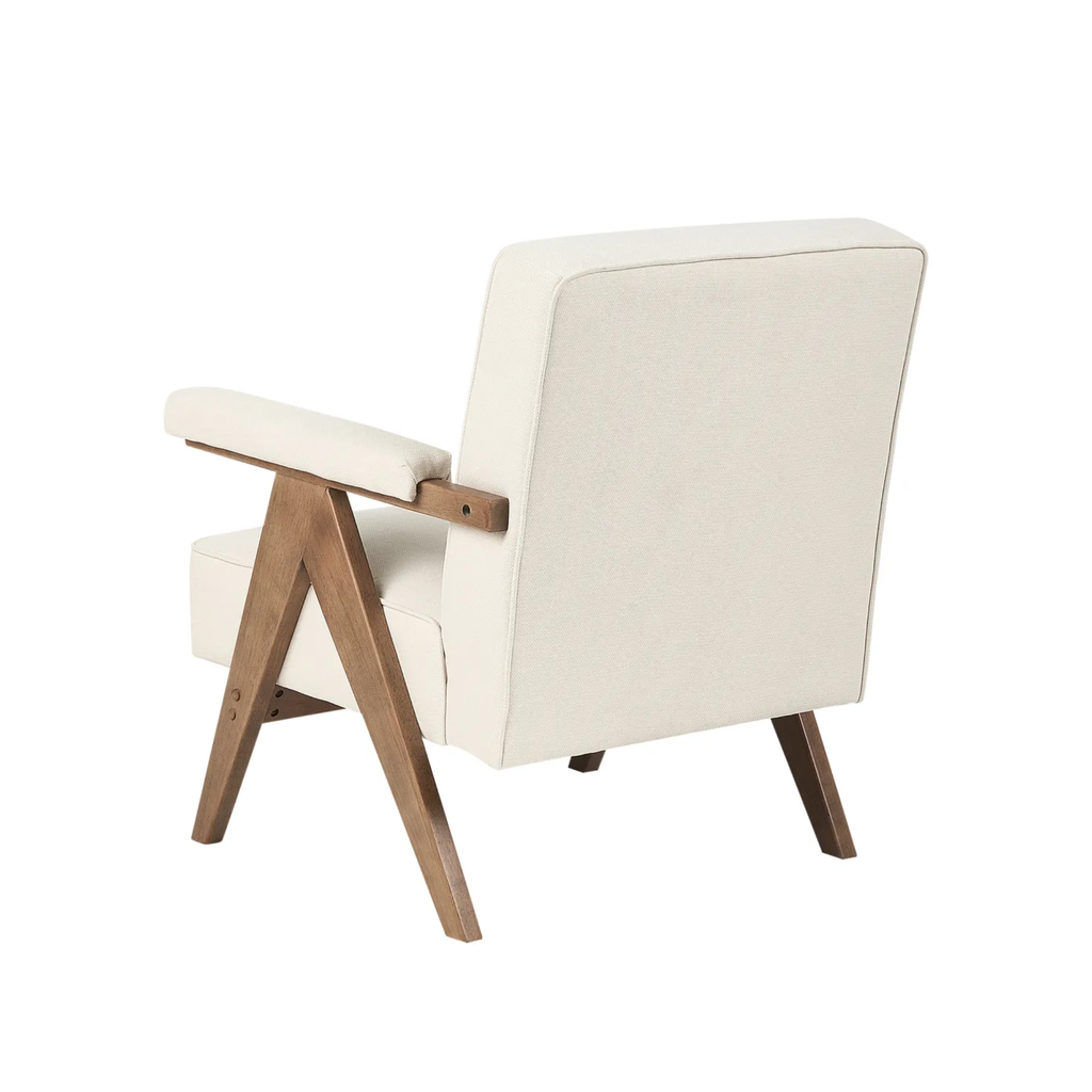 A modern upholstered armchair with cream fabric and a natural wood frame, shown from a three-quarters angle on a white background.