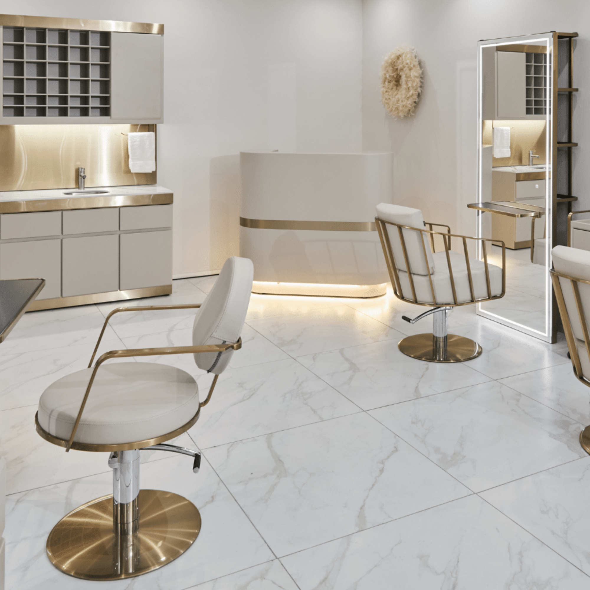 Modern salon interior with white chairs and marble floor and curved grey reception desk.