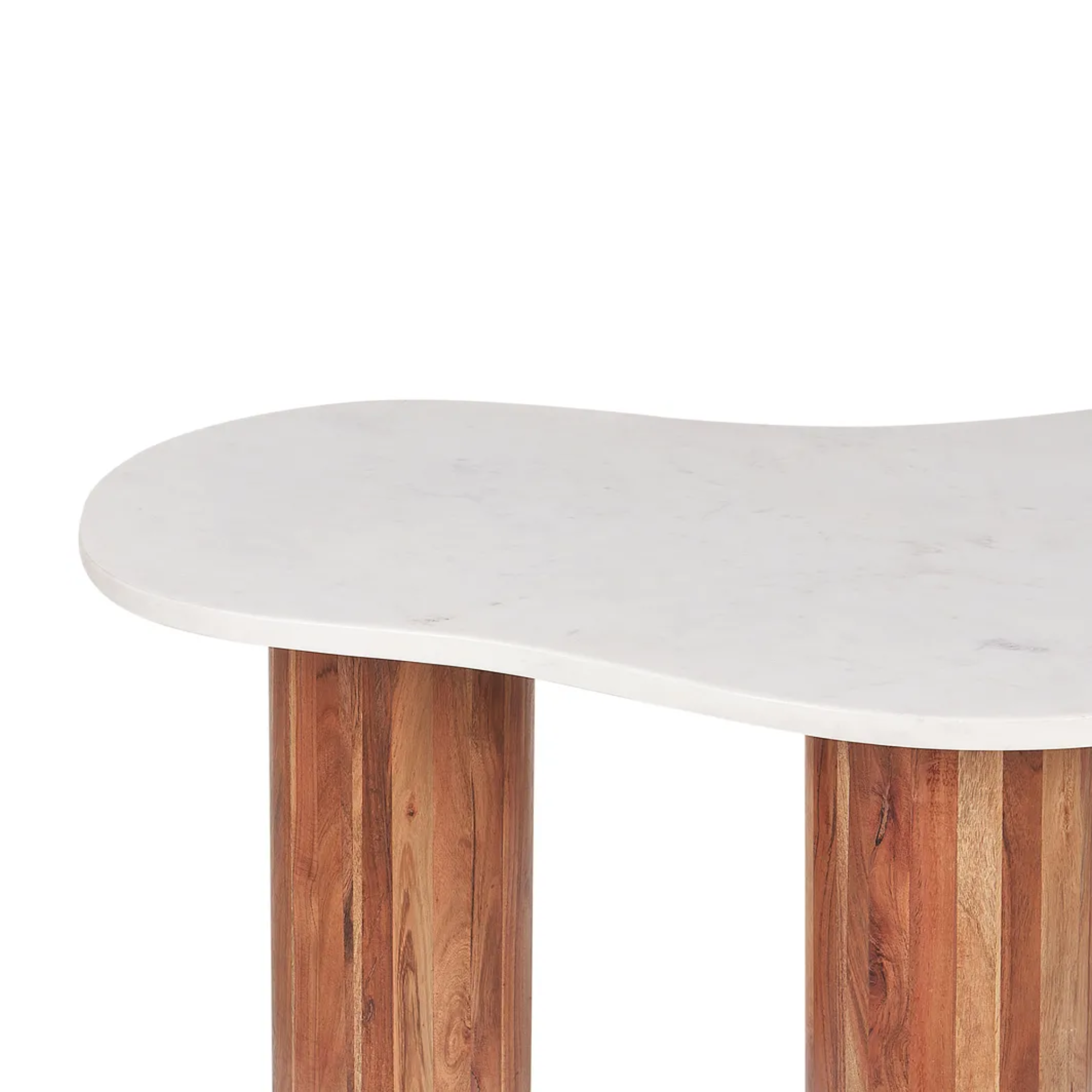 A close-up of a modern table with a wavy, organic-shaped white marble top and two round wooden legs with vertical grain.