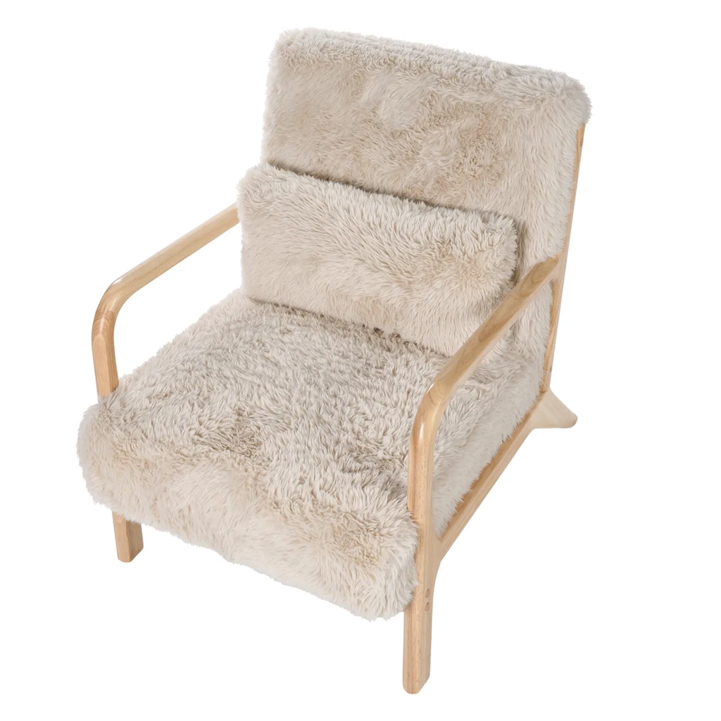 A modern wooden armchair with a thick, fluffy cream-colored sheepskin or faux fur upholstery, shown against a plain white background.