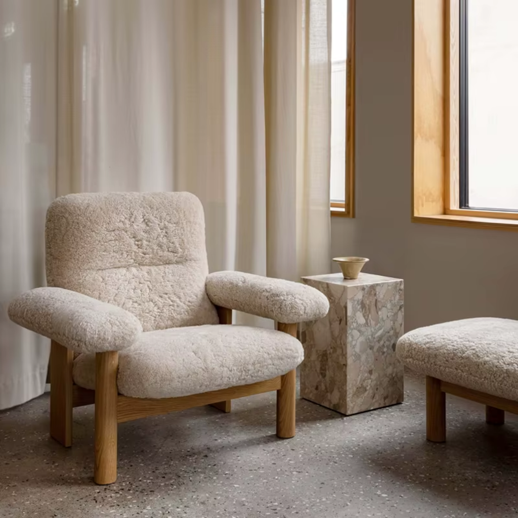 Bouclé Lounge Chair with Wood Frame in a room with light curtains and a window.