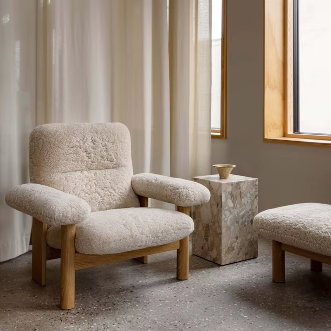 Bouclé Lounge Chair with Wood Frame in a room with light curtains and a window.