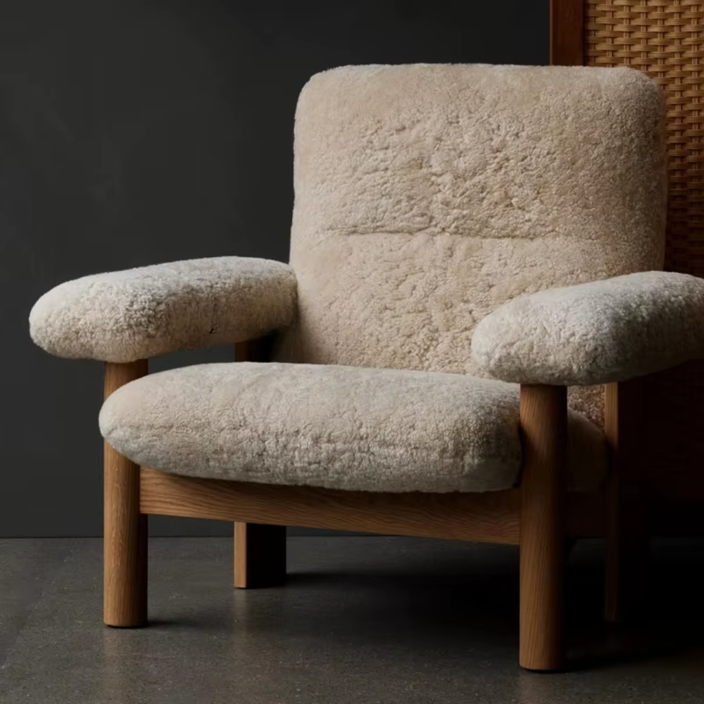 Bouclé Lounge Chair with Wood Frame on a dark background