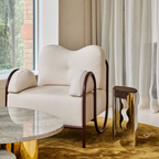 Modern white occasional  chair with metal frame in a stylish room with a table and decorative elements.