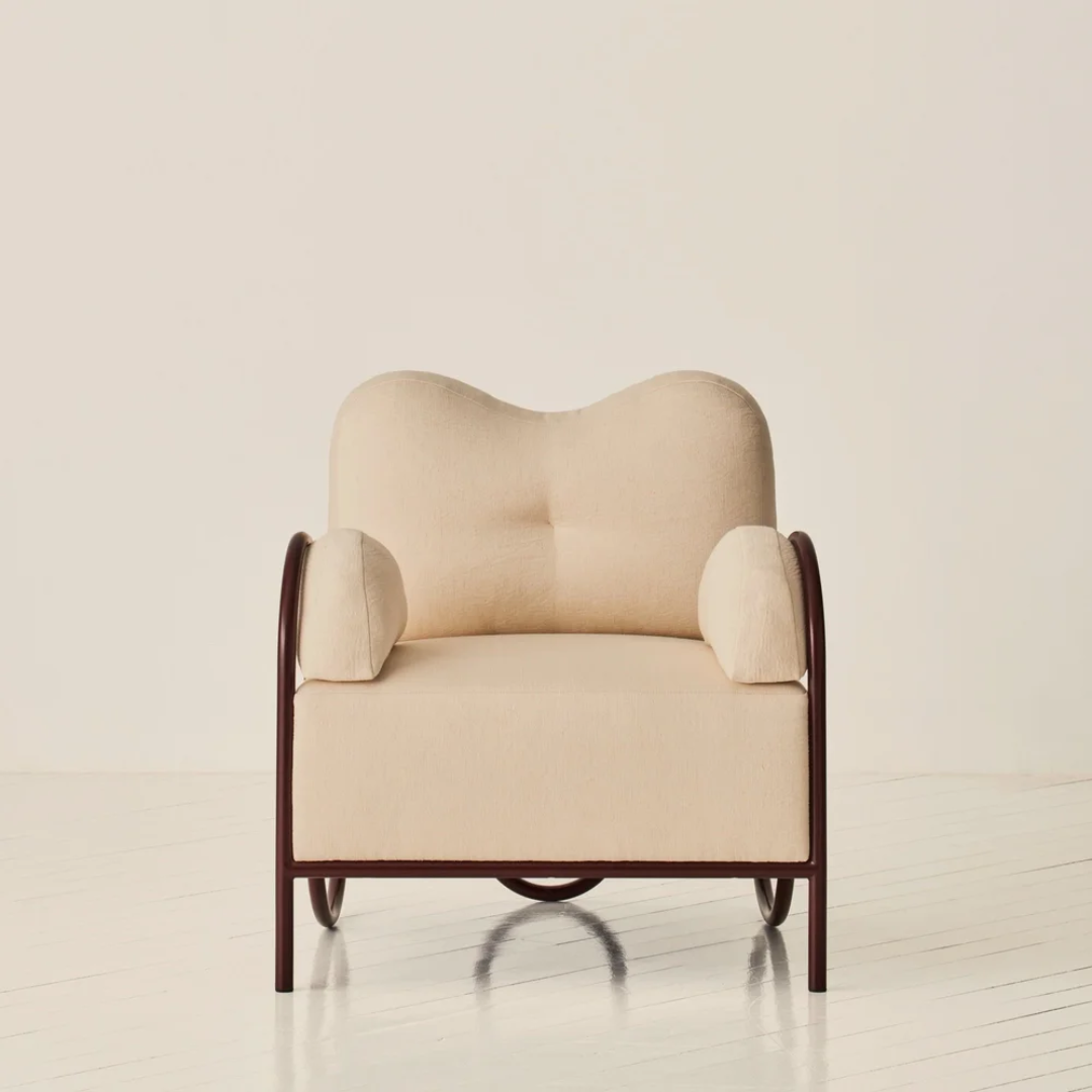 Beige Funky Occasional Chair with metal frame on a light background