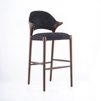 Bar stool with dark gray cushioned seat and backrest on a white background