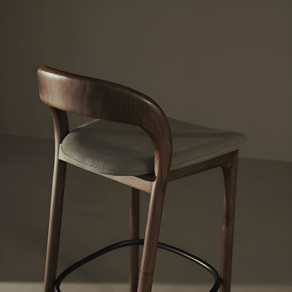 Bar stool with wooden frame and green cushioned seat against a dark background