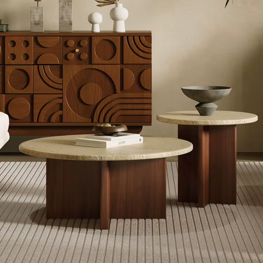 Two round wooden tables with stone-like surfaces in a room with a wooden cabinet.