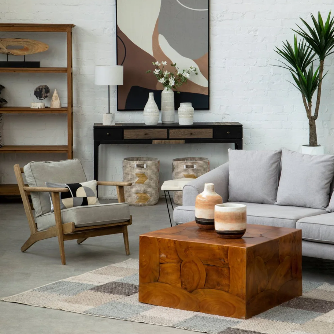 Living room with gray sofa, wooden coffee table, and decorative items.