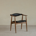 Wood And Black Leather Dining Chair and backrest on a beige background