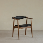 Wood And Black Leather Dining Chair and backrest on a beige background