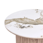 Close-up of a round table top with a white and beige marble pattern and a light wood pedestal base, shown on a white background.