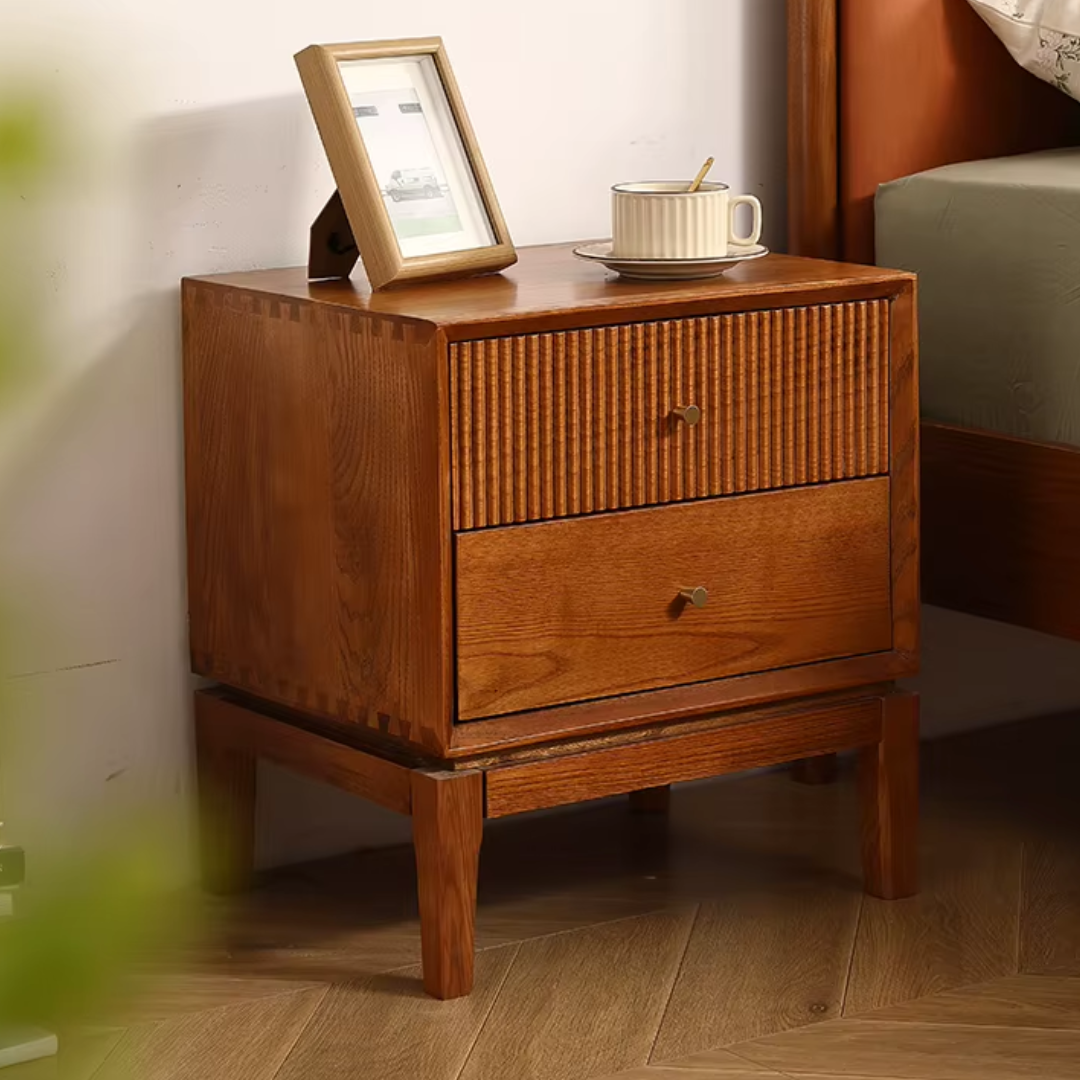Retro Solid Wood Bedside Table With Two Drawers, a photo frame, and a cup on top in a bedroom setting.