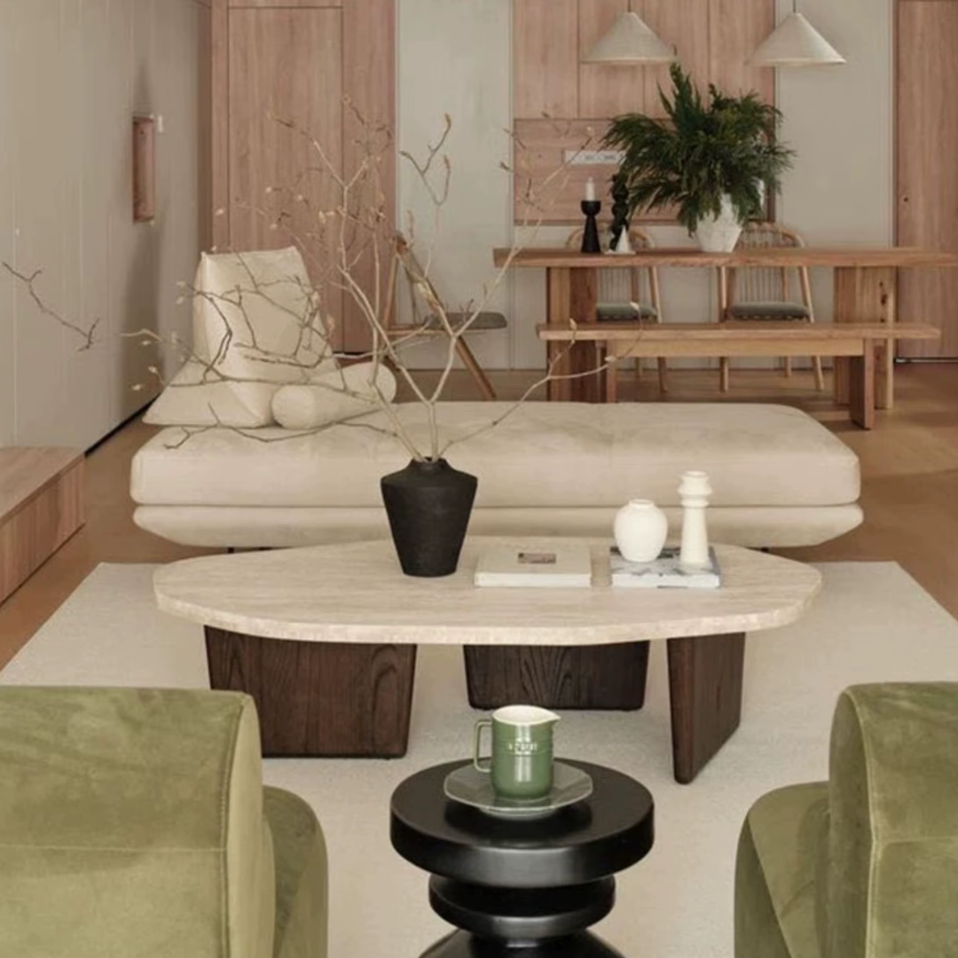 Modern living room with beige sofa, Walnut Wood Round Travertine Coffee Table, and green armchairs.