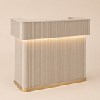 Beige reception desk with ribbed design and embedded lighting on a beige background