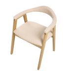 A modern dining chair with a light natural wood frame and cream-colored bouclé upholstery on the seat and curved armrests, shown against a plain white background.