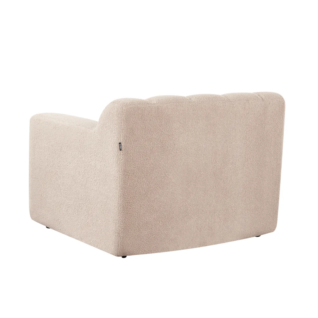 A beige upholstered armchair shown from a three-quarters angle against a plain white background.
