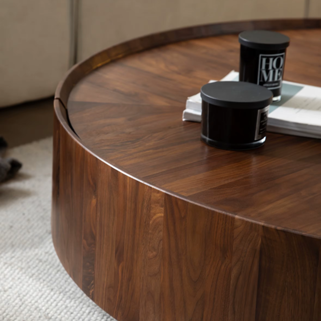 Round Walnut Wood Coffee Table with Hidden Storage with decorative items in a living room setting
