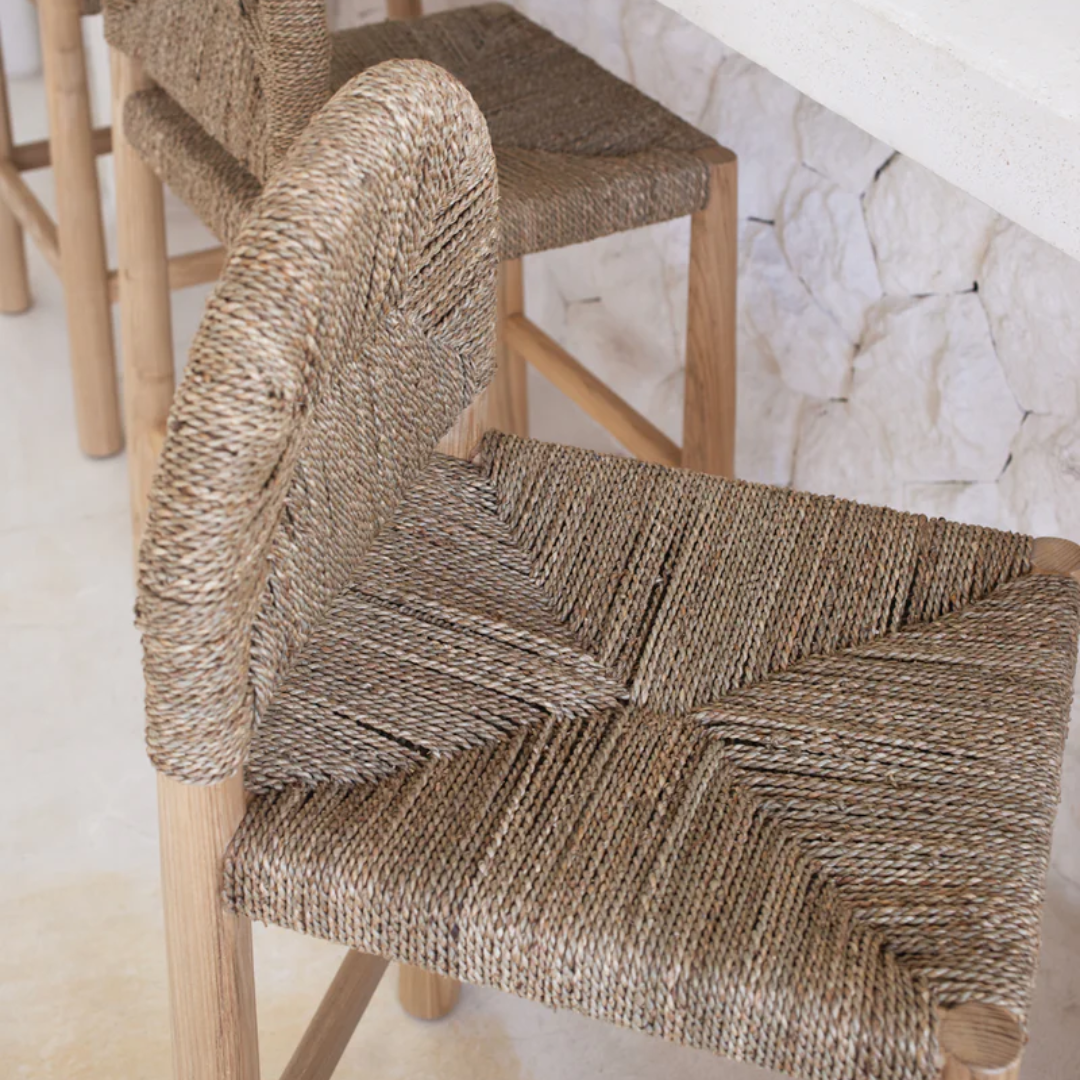 Woven chair with wooden legs on a light background