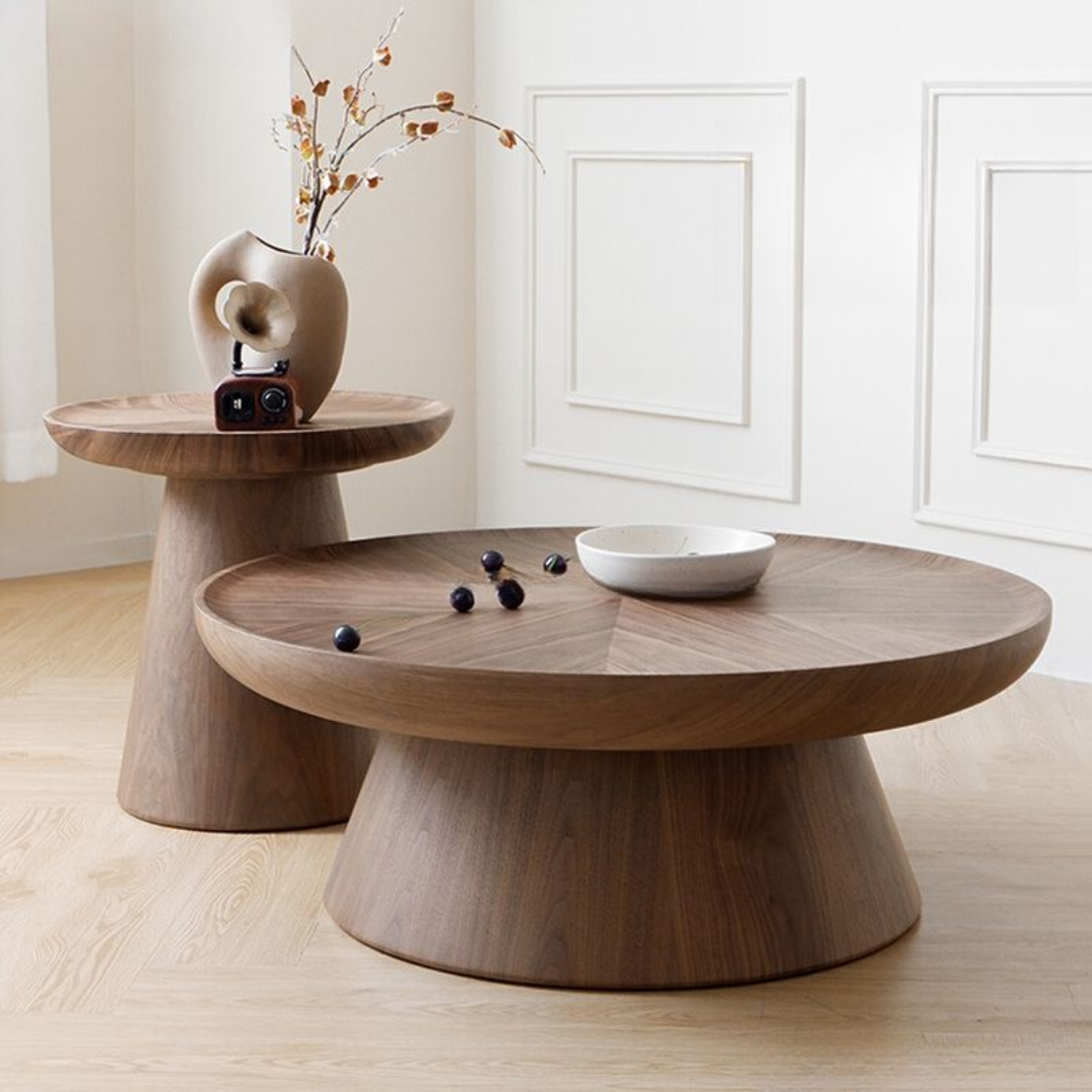 Pedestal Nest Of Wooden Coffee Tables  with decorative items in a minimalistic room.