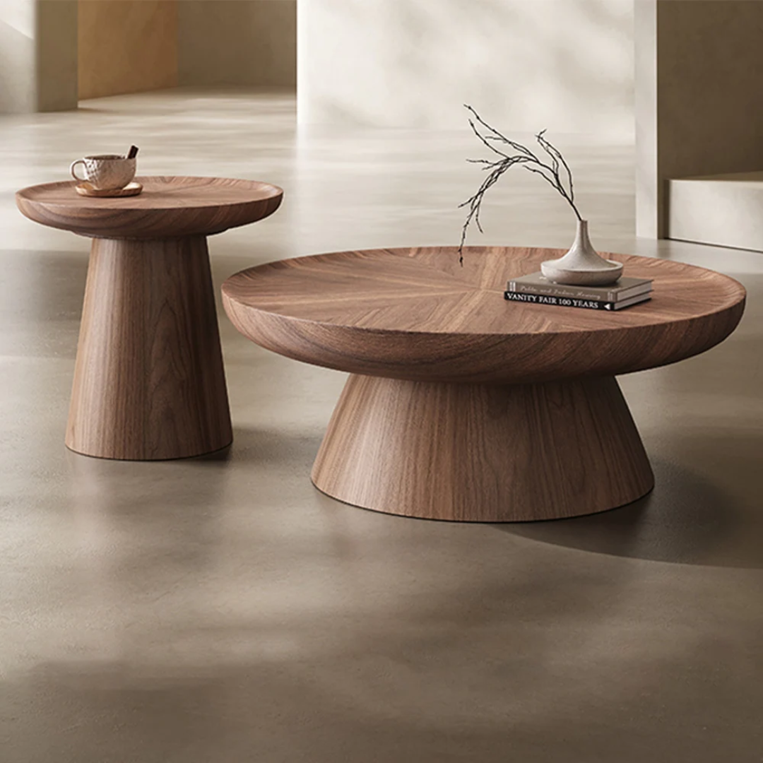 Pedestal Nest Of Wooden Coffee Tables with decorative items on a neutral background