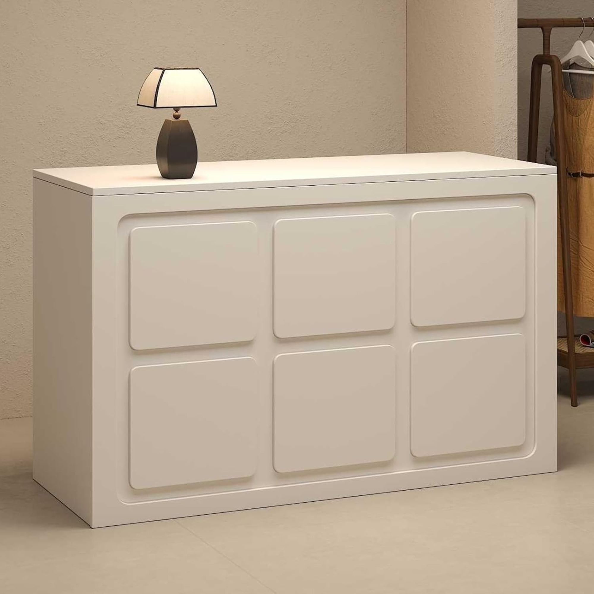 small reception desk in neutral cream finish styled in modern salon or retail interior space