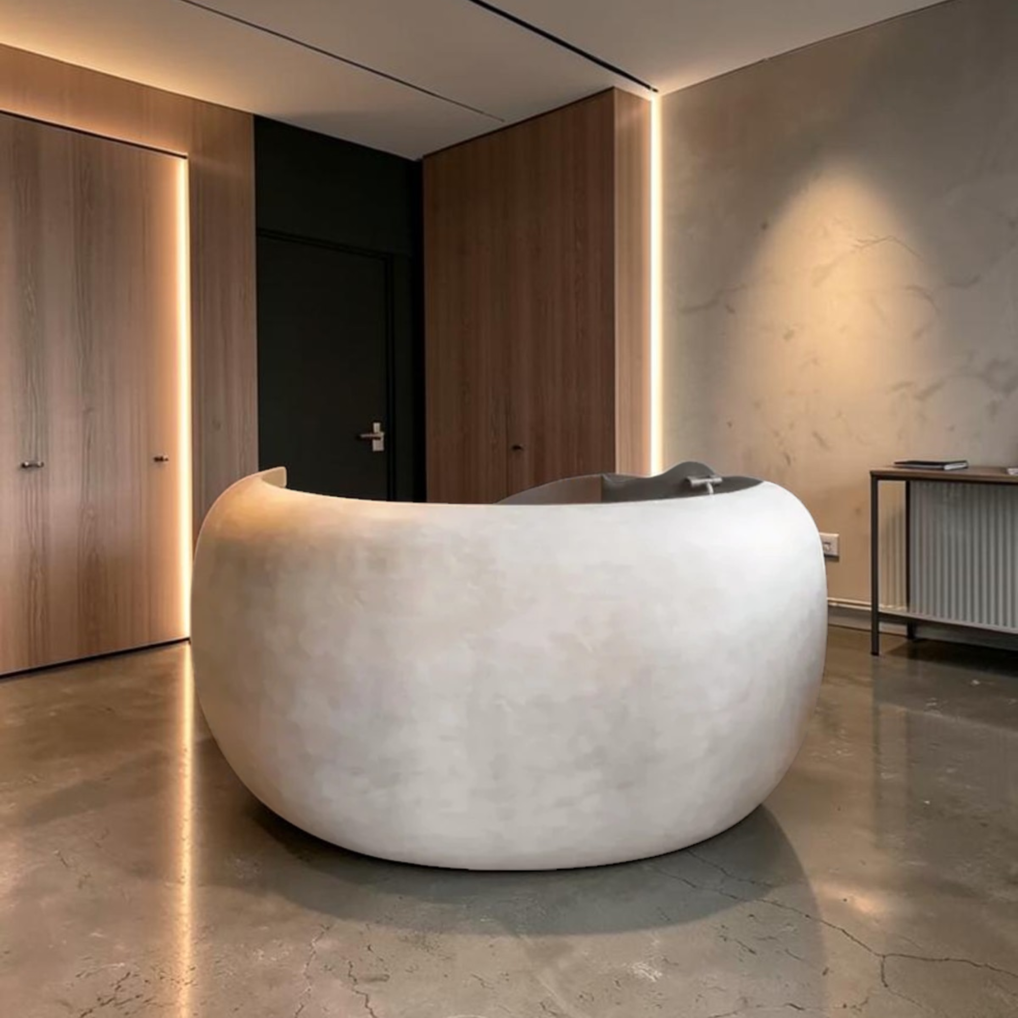 Modern Concrete Curved Reception Desk in a stylish interior setting with wooden walls and concrete floor.