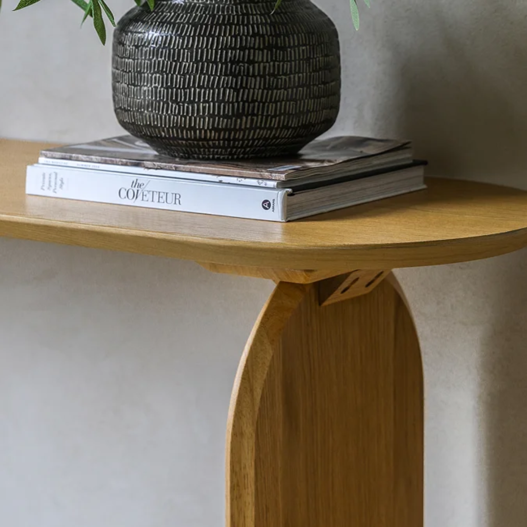  Sculptural Oak Hall Console Table with a black textured vase and books on a neutral background