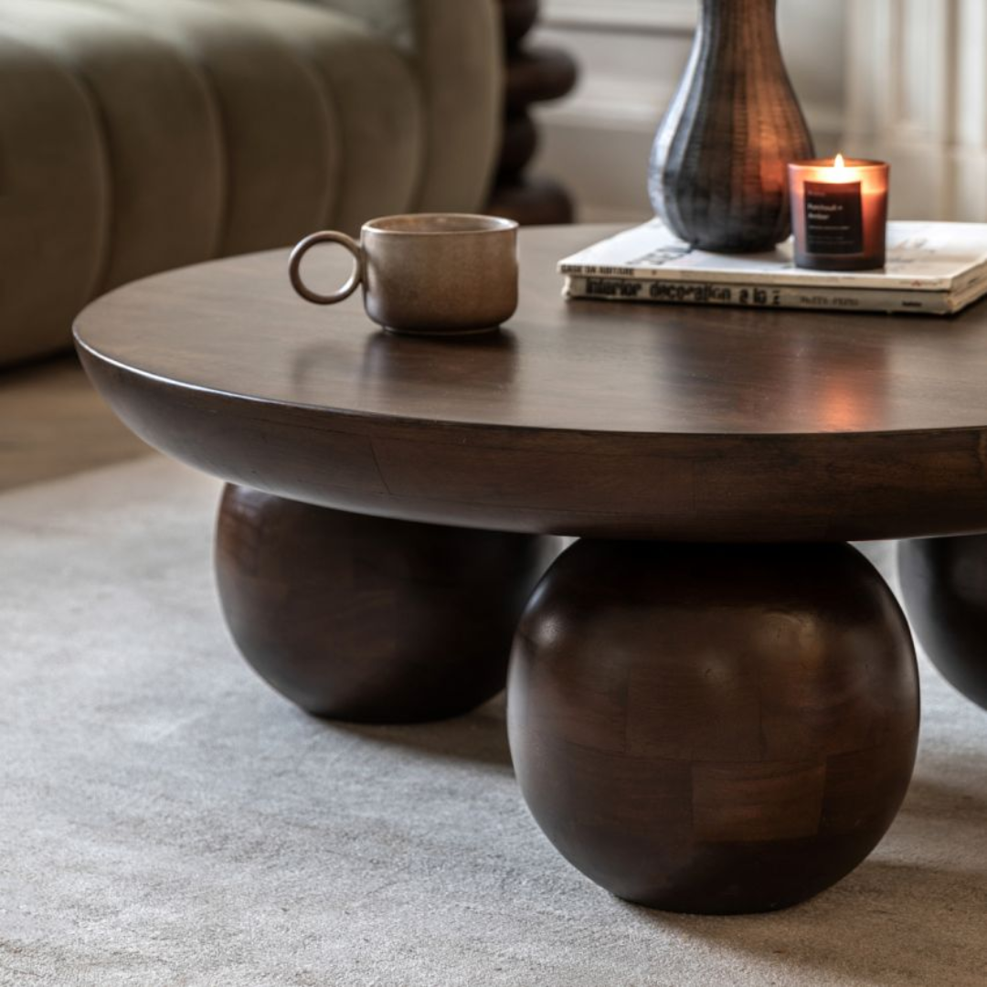 Walnut Round Coffee Table with spherical bases in a living room setting
