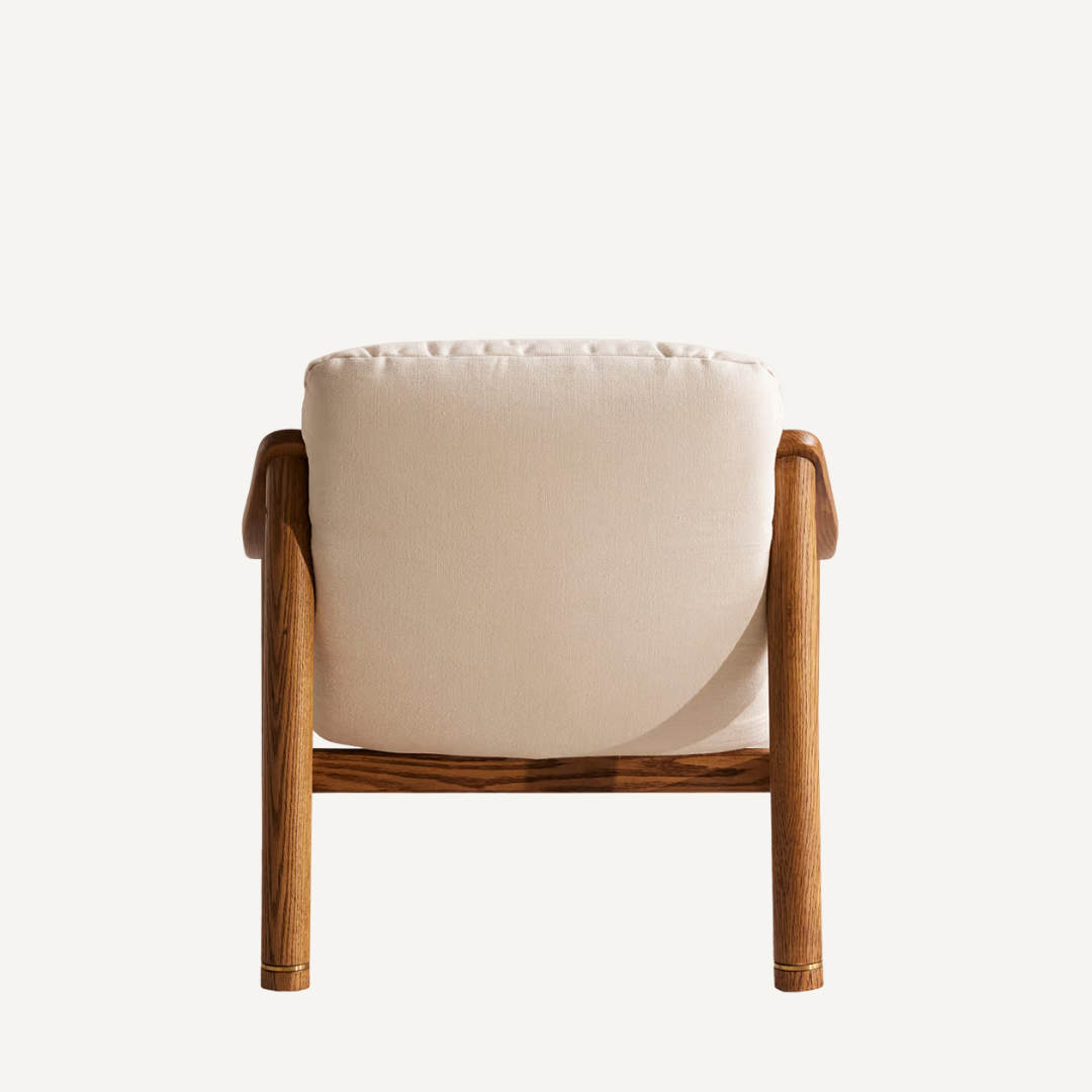 Chair with wooden frame and white cushion on a light beige background