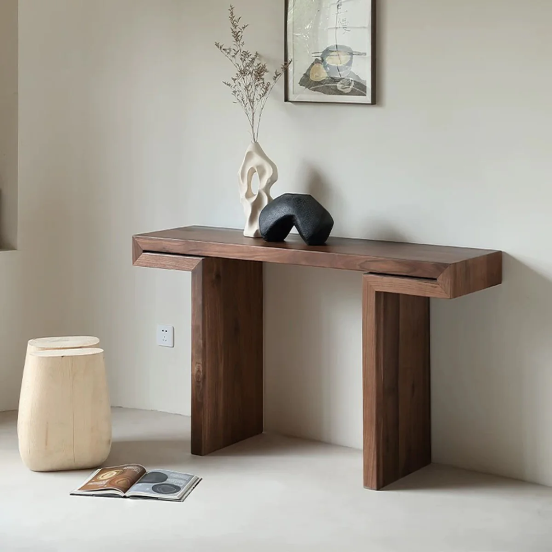 Dark Wood Hallway Table with decorative items against a plain wall