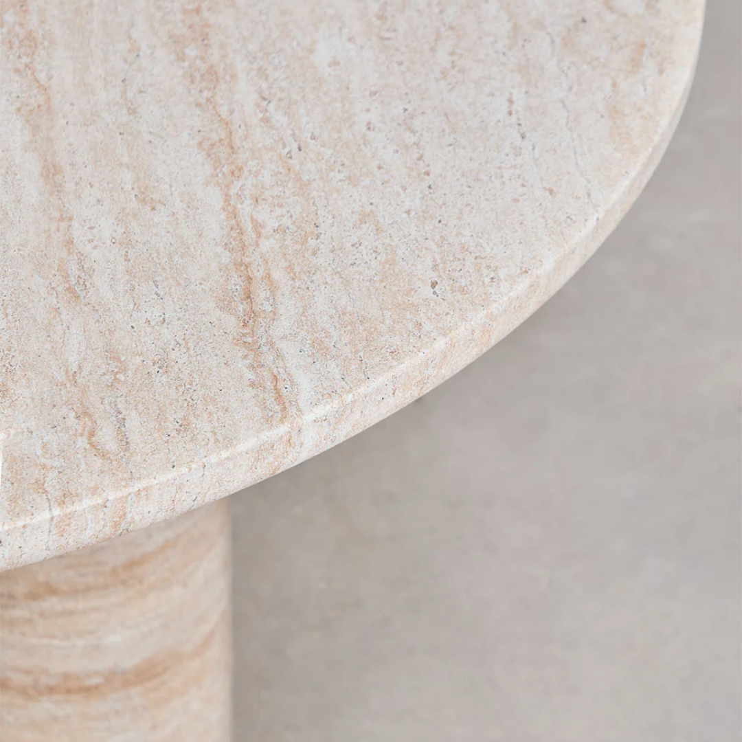 Close-up of a beige stone table with a neutral background