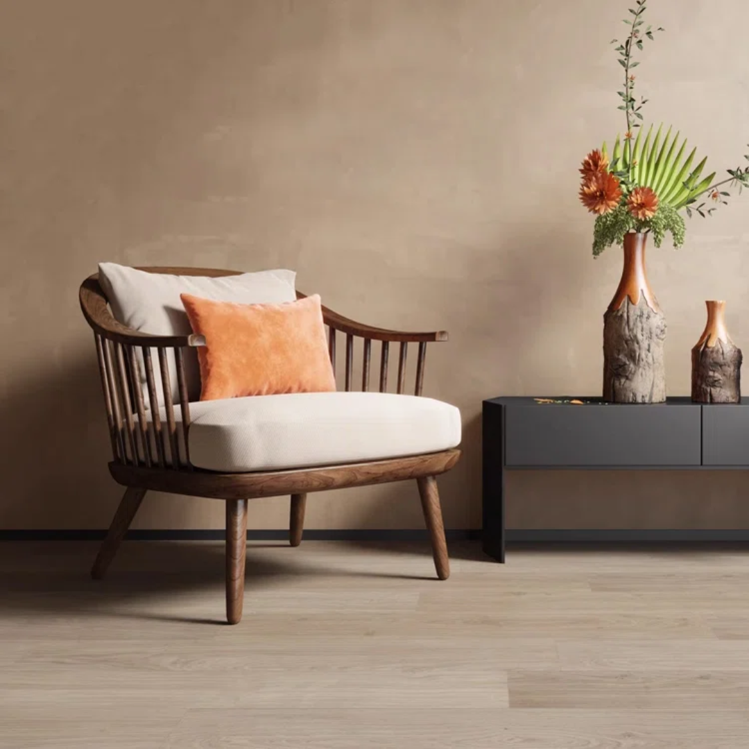 Wooden dark walnut spindle armchair with white cushion and orange pillow in a room with a vase of flowers on a side table.