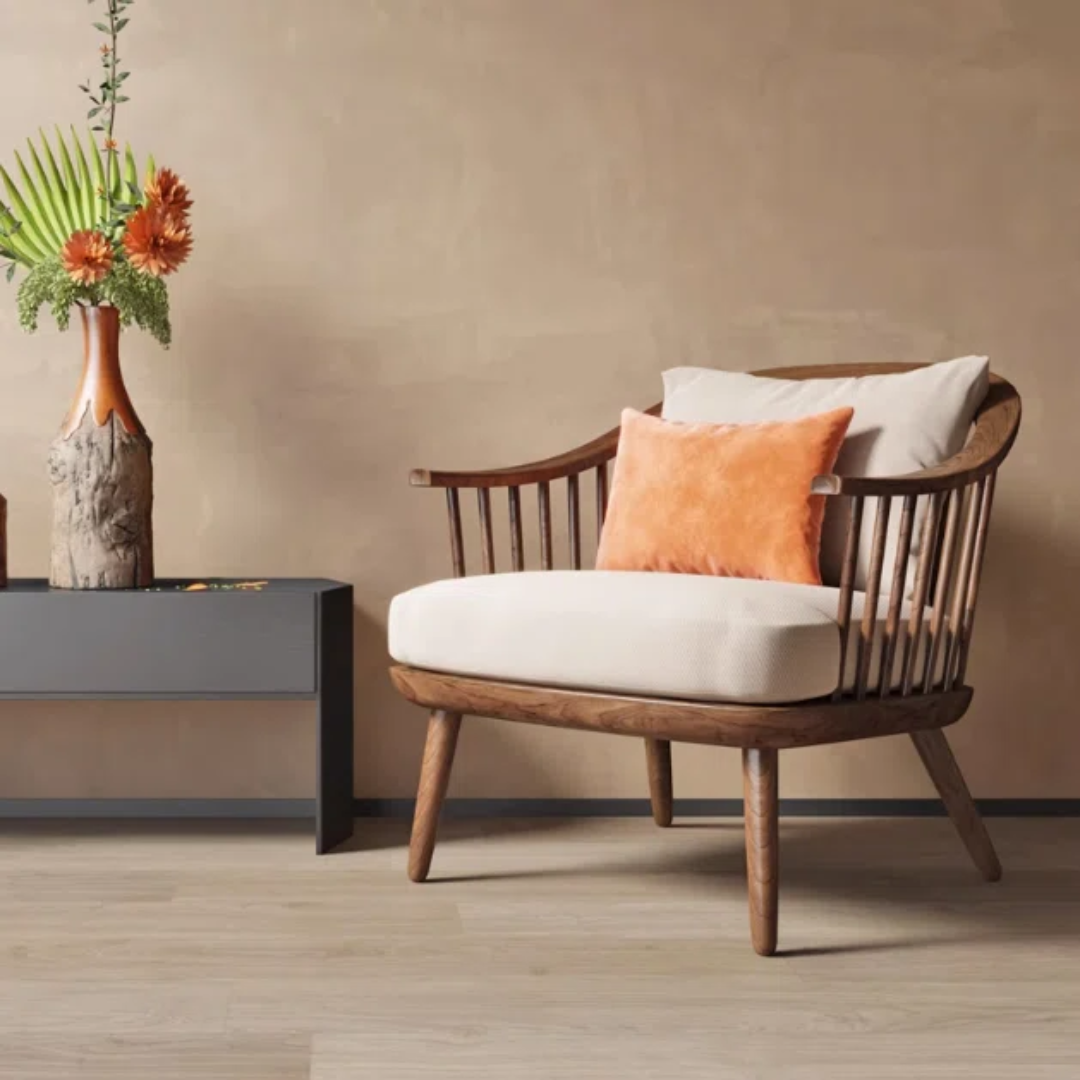 dark walnut spindle chair with white and orange cushions next to a small table with a vase and flowers against a beige wall.