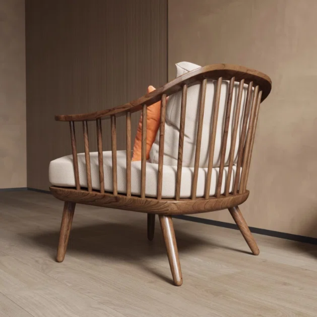 Wooden chair with white cushion and orange pillow against a beige wall