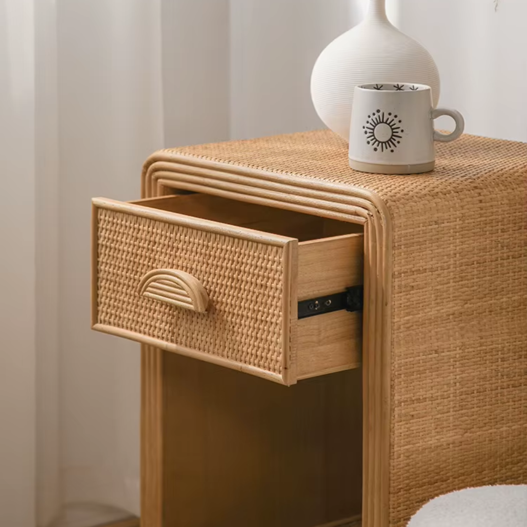 Woven nightstand with open drawer and a mug on top, against a neutral background.