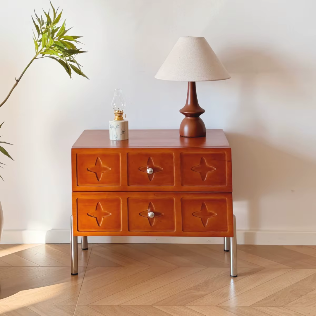 Vintage Style Mahogany Bedside Table with star-shaped drawer handles in a room setting with a lamp and plant.