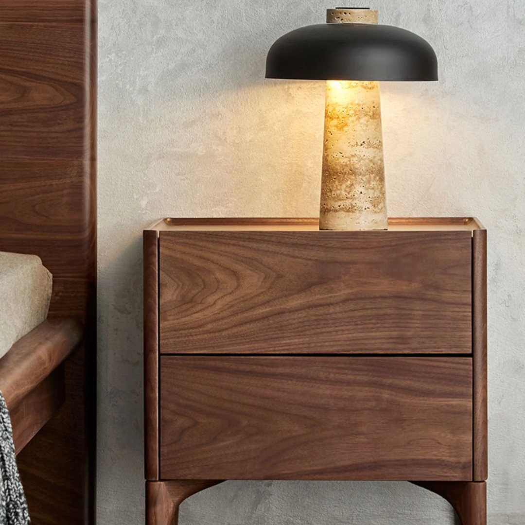 Walnut Bedside Table With Drawers With Curved Legs with a lamp on a neutral background