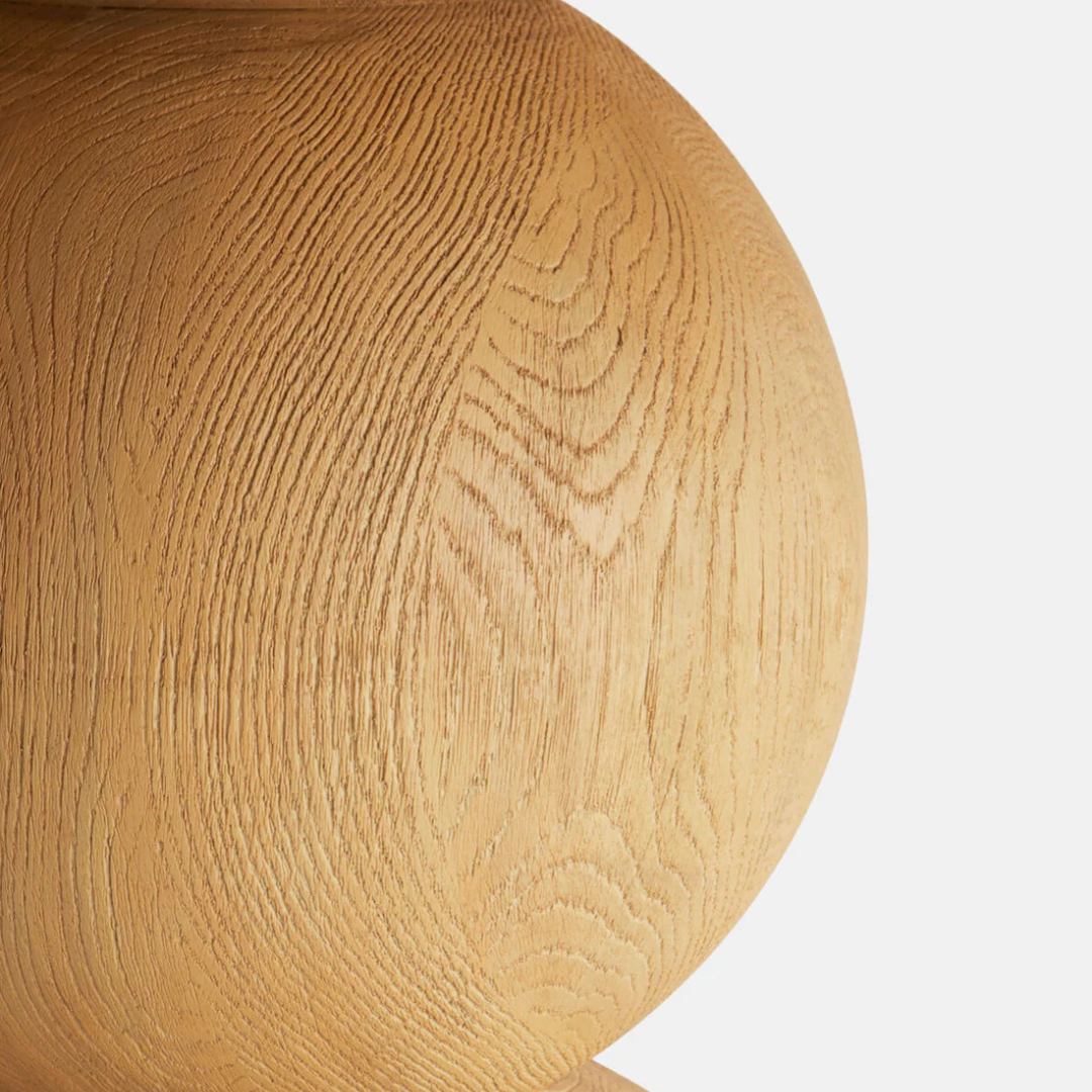 Close-up of a Round Wooden Pedestal Dining Table with a light brown color on a white background
