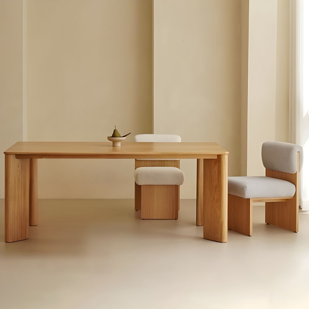 Rectangular Wooden Dining Table with four matching chairs against a beige wall.